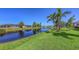Scenic backyard pond with lush green grass, providing a serene view of nature and wildlife at 5022 46Th W St, Bradenton, FL 34210