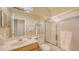 Bright bathroom featuring a tub with shower, a mirror, and a single vanity at 5022 46Th W St, Bradenton, FL 34210