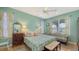 A serene bedroom featuring a floral bedspread, sitting area, and abundant natural light at 5022 46Th W St, Bradenton, FL 34210