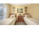 Bedroom with twin beds, window with shutters, hardwood floors, and warm yellow walls at 5022 46Th W St, Bradenton, FL 34210