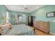 A bright bedroom featuring a floral bedspread, sitting area, and hardwood floors at 5022 46Th W St, Bradenton, FL 34210