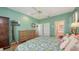 A bright bedroom featuring a floral bedspread, hardwood floors, and multiple closets at 5022 46Th W St, Bradenton, FL 34210