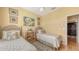 Bedroom featuring twin beds, hardwood floors, warm yellow walls, and an entry to the hallway at 5022 46Th W St, Bradenton, FL 34210