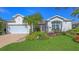 Charming single-story home boasts a well-kept lawn, two-car garage, and colorful landscaping at 5022 46Th W St, Bradenton, FL 34210