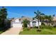 Beautiful single-Gathering home featuring a well-manicured lawn, palm trees, and a two-car garage at 5022 46Th W St, Bradenton, FL 34210