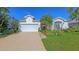 Inviting one-story home showcasing a two-car garage, vibrant landscaping, and a well-maintained lawn at 5022 46Th W St, Bradenton, FL 34210
