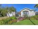 Gorgeous home featuring a lush garden, charming gate, and perfectly manicured lawn at 5022 46Th W St, Bradenton, FL 34210