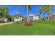 Attractive one-story home with a two-car garage, green lawn, and lush tropical landscaping at 5022 46Th W St, Bradenton, FL 34210