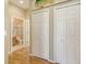 Hallway featuring hardwood floors, bi-fold closet doors, and access to the bathroom at 5022 46Th W St, Bradenton, FL 34210