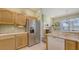 Kitchen with stainless steel appliances and adjacent dining area at 5022 46Th W St, Bradenton, FL 34210