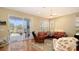 Cozy living room with a leather sofa, ceiling fan, and sliding doors to the backyard patio at 5022 46Th W St, Bradenton, FL 34210