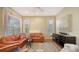 Comfortable living room with hardwood floors, a leather sofa, and large windows at 5022 46Th W St, Bradenton, FL 34210