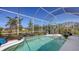 Inviting screened-in pool area features a patio with seating and vibrant tropical foliage, perfect for relaxation at 5022 46Th W St, Bradenton, FL 34210