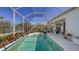 Enclosed pool with lounge area and vibrant plants, providing a private oasis for outdoor enjoyment and relaxation at 5022 46Th W St, Bradenton, FL 34210