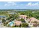 Beautiful community featuring a pool, tile roof townhomes, lush landscaping, and a serene lake at 5405 46Th W Ct, Bradenton, FL 34210