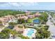 Aerial view of neighborhood featuring community pool, beautiful landscaping, and nearby pond at 5405 46Th W Ct, Bradenton, FL 34210