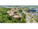 Aerial view showcases a community with lush greenery, a pond, and modern buildings at 5405 46Th W Ct, Bradenton, FL 34210