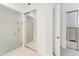 Bright bathroom showcasing a glass shower, tile floors, and access to a walk-in closet at 5405 46Th W Ct, Bradenton, FL 34210