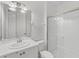 Well-lit bathroom boasts a vanity, toilet, and glass-enclosed shower for a serene experience at 5405 46Th W Ct, Bradenton, FL 34210