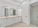 Bright bathroom featuring double sinks, a large mirror, tile floors, and a separate glass shower at 5405 46Th W Ct, Bradenton, FL 34210
