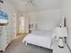 This bedroom features a large bed, a white dresser with TV, and an open concept to other rooms at 5405 46Th W Ct, Bradenton, FL 34210