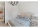 Comfortable bedroom features a queen-size bed, chandelier, and two white nightstands with lamps at 5405 46Th W Ct, Bradenton, FL 34210