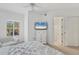 This bedroom features a large bed, a white dresser with TV and a window at 5405 46Th W Ct, Bradenton, FL 34210