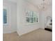 Bright bedroom featuring plantation shutters, a decorative mirror, and a luxurious chandelier enhancing elegance at 5405 46Th W Ct, Bradenton, FL 34210