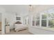 Bright bedroom boasts many windows, plantation shutters, a ceiling fan, and a decorative headboard at 5405 46Th W Ct, Bradenton, FL 34210