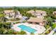 Community pool and outdoor lounge area surrounded by lush landscaping in a quiet neighborhood at 5405 46Th W Ct, Bradenton, FL 34210