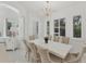 Elegant dining room features large table, chandelier, and bright window views at 5405 46Th W Ct, Bradenton, FL 34210