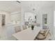 Bright dining room features a chandelier, a table with six chairs, and seamless flow into the kitchen at 5405 46Th W Ct, Bradenton, FL 34210