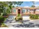 Two-story townhome featuring a two-car garage, and well-manicured front yard at 5405 46Th W Ct, Bradenton, FL 34210