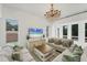 Bright living room with white walls, chandelier, and stylish furnishings at 5405 46Th W Ct, Bradenton, FL 34210