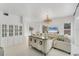Elegant living room with white walls, chandelier, and stylish furnishings at 5405 46Th W Ct, Bradenton, FL 34210