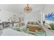 Bright living room features elegant chandelier, white walls, and plush sofas at 5405 46Th W Ct, Bradenton, FL 34210