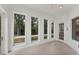 Sun-filled room with large windows offering views of lush greenery at 5405 46Th W Ct, Bradenton, FL 34210