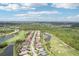 An aerial view displays houses adjacent to a golf course, lakes, and wooded preserve at 5480 White Ibis Dr, North Port, FL 34287
