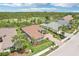 An aerial perspective displays the property, the golf course and wooded area at 5480 White Ibis Dr, North Port, FL 34287