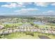 An aerial view of a golf course community with houses, lakes, and lush green fairways at 5480 White Ibis Dr, North Port, FL 34287