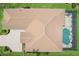 An aerial shot showcasing the home's tile roof, screened-in pool, and brick-paved driveway at 5480 White Ibis Dr, North Port, FL 34287