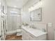 Bright bathroom with marble countertops, modern vanity, glass shower, and tiled walls at 5480 White Ibis Dr, North Port, FL 34287