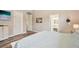 Bright bedroom with wood floors, decorative wall art and access to an ensuite bathroom at 5480 White Ibis Dr, North Port, FL 34287