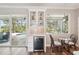 Cozy dining area featuring a wine cooler and views of the outdoor pool and patio at 5480 White Ibis Dr, North Port, FL 34287