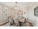Bright dining room with a wooden table, seating for six, and decorative wall art at 5480 White Ibis Dr, North Port, FL 34287