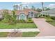An inviting home with lush landscaping, a brick-paved driveway, and double door entry at 5480 White Ibis Dr, North Port, FL 34287