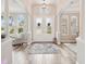 Elegant foyer with arched doorways, decorative glass double doors, and beautiful wood-look flooring at 5480 White Ibis Dr, North Port, FL 34287