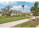 Well-maintained lawn with landscaping in front of this beautiful home, complemented by a brick driveway at 5480 White Ibis Dr, North Port, FL 34287