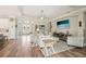 Open-concept living area featuring hardwood floors, archways, and views into the foyer and other living spaces at 5480 White Ibis Dr, North Port, FL 34287