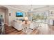 Spacious living room with wood floors, a ceiling fan, and a sliding glass door with a view at 5480 White Ibis Dr, North Port, FL 34287
